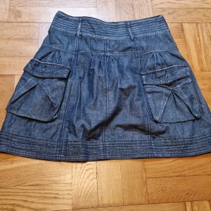 Jeanskjol - Fin jeanskjol i strl 38. Med fickor utan knapp, fint skick. Katt i hemmet.