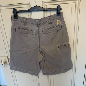 Grå carhartt shorts - Säljer ett par gråa Carhartt shorts i relaxed fit. Storlek W32. Hör gärna av dig vid frågor!