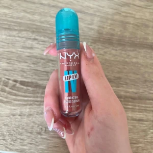 NYX Lip IV Hydrating Gloss Serum - Helt ny, NYX Lip IV Hydrating Gloss Serum i en nude-rosa nyans. Kommer i en smidig tub med turkos kork och applikator. Ger glansiga, återfuktade läppar med en lätt, fräsch känsla. Perfekt för dig som vill ha både glans och vård i ett.