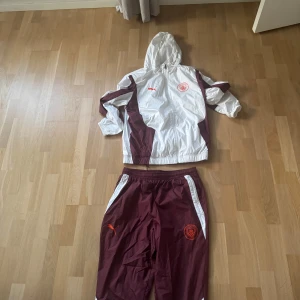 Puma vindjacka i vinrött och vitt - Man city unik och snygg dress storlek L på både jacka och byxor!