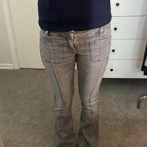 Grå bootcut jeans med fickor fram - Säljer ett par grå jeans med bootcut och snygga framfickor. Byxorna har markerade sömmar längs benen och klassiska bakfickor. Stl 158 men skulle säga att de passar XXS/XS också. Priset kan diskuteras!💗