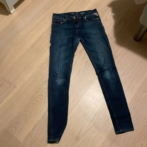 Mörkblå jeans från Replay - Snygga mörkblå jeans från Replay med en slim passform. De har klassisk femficksdesign och dragkedja. Perfekta för en stilren look.
