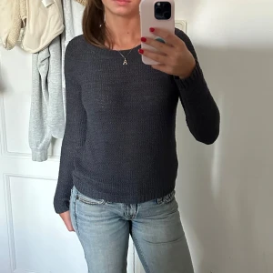 Grå stickad tröja - En typ gråblå stickad långärmad tröja i fint mönster. 