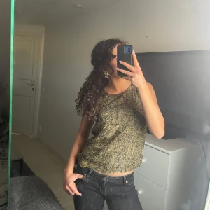 Guldfärgad ärmlös topp från Dry Lake - Festlig guldfärgad topp från Dry Lake. Passar till det mesta🤩