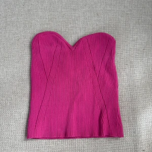 Ribbad rosa tubtopp - Säljer en ribbad rosa tubtopp. Toppen är stretchig och har en tight passform, perfekt för sommaren. 