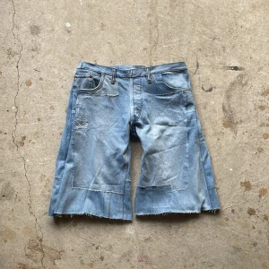 Patch Jorts - Crafted from vintage denim, this piece features multiple pairs of different jeans entirely reconstructed with a inner lining for comfort.