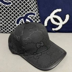 Svart keps från Gucci - Snygg svart keps från Gucci med det ikoniska GG-mönstret. Tillverkad i en blandning av merinoull och kashmir för en lyxig känsla. Justerbar rem baktill för perfekt passform.