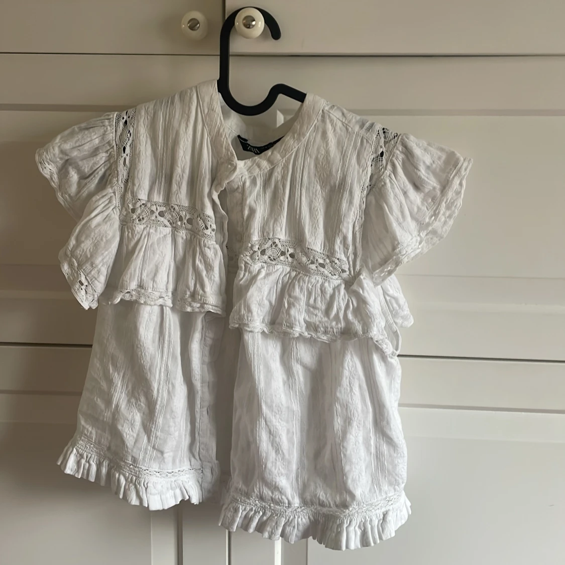 Vit blus med spetsdetaljer och volanger - 2