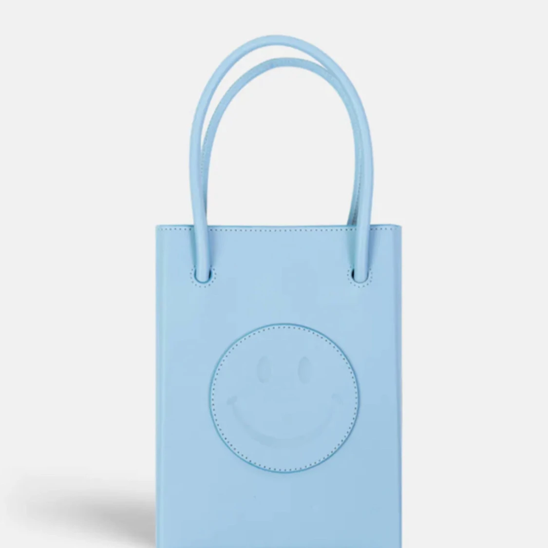 The Case Factory - Essential Crossbody Väska Smiley Vegetable Tanned Light Blue