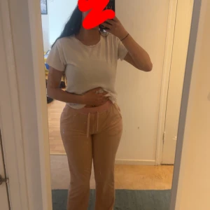 Rosa mjukisbyxor från Juicy Couture - Säljer ett par klassiska rosa mjukisbyxor från Juicy Couture med strassdetaljer på baksidan. Byxorna har bred resår i midjan och är tillverkade i mjukt material som känns skönt mot huden. Knappt använda 