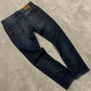 Nudie Jeans - Tja! Säljer dessa stilrena mörkblå/grå Nudie jeansen med schysst tvätt! Size 30/32. Skriv vid funderingar!