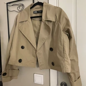 Beige trenchcoat  - Säljer en stilren beige kappa från Zara med börkbruna knappar, perfekt till vår och höst. Säljer då den inte kommer till användning. Pris kan diskuteras 