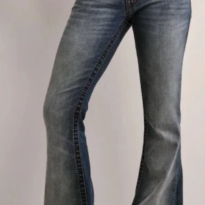 Blå bootcut jeans - Snygga blå bootcut jeans med klassisk femficksdesign och lätt slitna detaljer. Perfekta för en avslappnad stil. Köptes 31 mars 2025 priset kan diskuteras🫶🏽