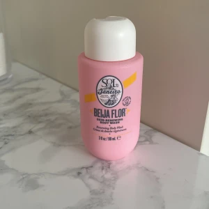 Sol de Janeiro Beija Flor Skin-Renewing Body Wash mini - En rosa miniflaska med Sol de Janeiro Beija Flor Skin-Renewing Body Wash. Innehåller 90 ml och har en söt, fräsch doft. Perfekt för resan eller gymväskan. Flaskan är gjord av plast och har en vit skruvkork. Nästan inte andvänd