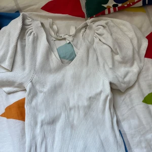 Vit ribbad topp med puffärm och knyt - Ny