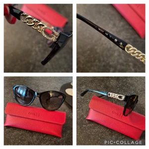 Svarta solglasögon från Guess - Snygga svarta solglasögon från Guess med elegant gulddetalj på skalmarna. De har en klassisk form och kommer med ett rött Guess-fodral. Perfekta för att ge en touch av glamour till din stil. Nypris 1600:-