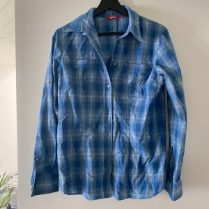 Blå rutig skjorta  - Snygg blå rutig skjorta från Fjällräven använd några gånger bara. Är en M men sitter som en S