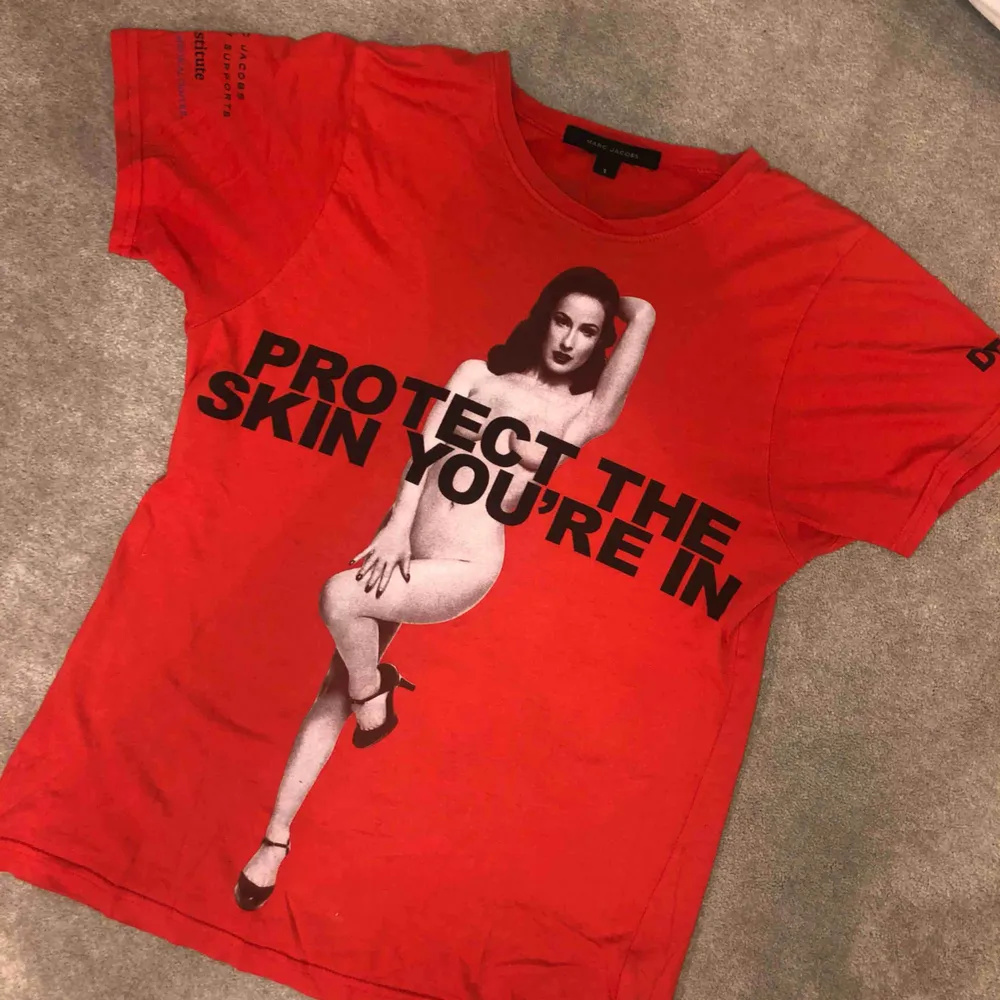 En av de kända ”Protect The Skin You’re In” tröjorna från Marc Jacobs. Köpt för ca 600kr så priset är väldigt snällt. Helt felfri och perfekt i skick och trogen i storlek.  Kan mötas upp eller posta! Pris kan diskuteras!. T-shirts.
