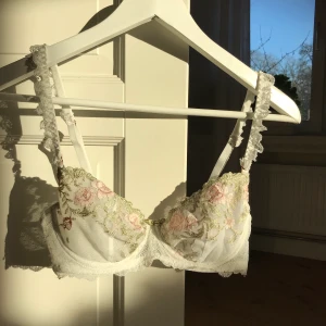 Spets bh - Superfin vit spets bh i blommigt mönster, säljer p.g.a för liten och kommer ej till användning. Använd ett fåtal gånger och är i mycket bra skick, skriv pirvat för fler bilder.                                    FRAKT ÄR EJ INKLUDERAT I PRISET🤎