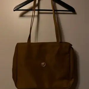 En jättesnygg brun väska med gulddetaljer. Aldrig använd!! Säljes för 45kr, frakt tillkommer. ✨✨