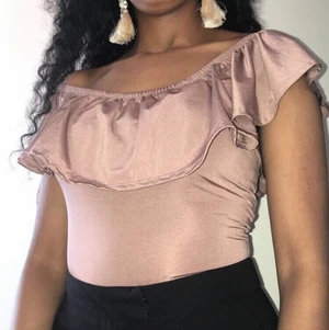 Body - En snygg body med volang fram & bak .Använd några ggr. I strl Xs. Frakt ingår! 