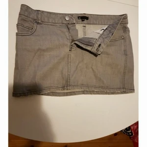 Kort blyertsgrå jeanskjol! - En bra jeanskjol funkar i alla väder! Gott skick. Djur och rökfritt hem.Frakt tillkommer på 44:- jag samfraktar gärna!