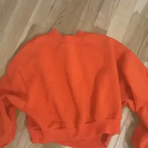 En orange hoodie från divide i storlek S