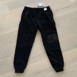 Svarta mjukisbyxor - Helt nya mjukisbyxor från Pull and Bear! Aldrig använda. Storlek L, från herravdelningen. Har fickor både fram och bak. På benet står det ”we are the evolution”. Väldigt mjuka inuti! Nypris 300kr.