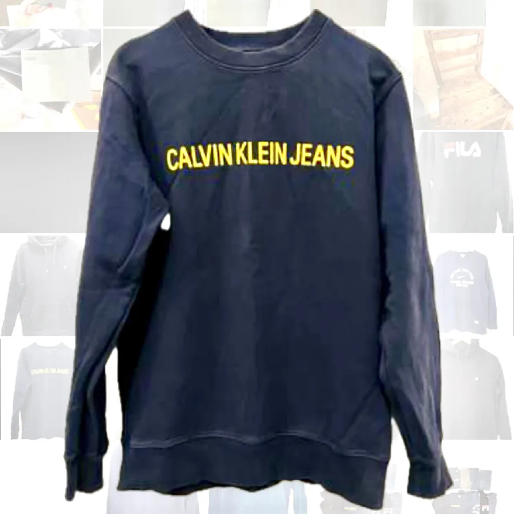 En collegetröja från Calvin Klein. Marin med gul text. I använt skick men fin. . Hoodies.