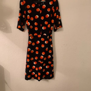 Warehouse dress - Everyday smart dress. Cotton. Dark blue background with orange and white large dots. Excellent condition. Worn once. Clean. Fitted bodice with slightly flared skirt. 