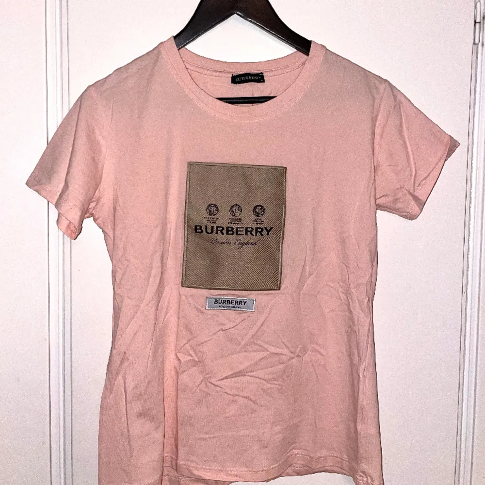 En jätte fin baby rosa t-shirt från burberry. Det är storlek M men passar även en S, den är helt oanvänd.. T-shirts.