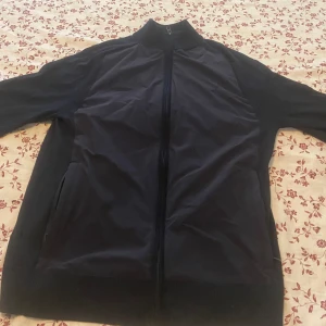 J.Lindeberg Cardigan Strlk M - Säljer J.Lindeberg cardigan som är nästintill oanvänd,inget knott finns,bara ett hål som jag fick när jag gick in i ett staket Storlek M passar S och M Skicka pm vid intresse