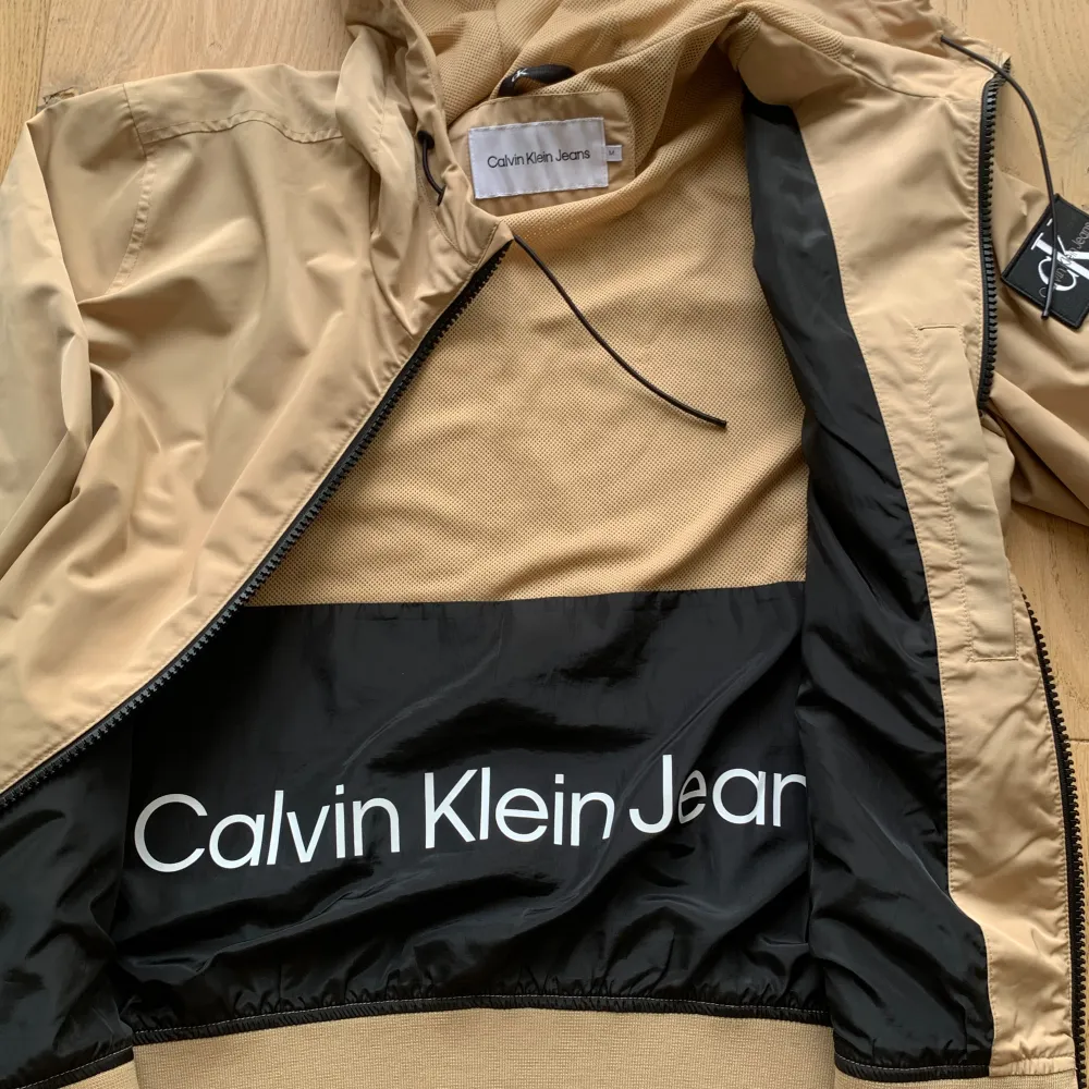 Säljer nu min fina regnjacka från Calvin Klein i skick som ny. Fin sandbeige färg med fina detaljer. Jag på bilden är 182 cm. Hör gärna av dig vid frågor och funderingar.. Jackor.