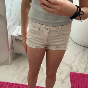 Vita shorts med silver detaljer  - Shorts i bra skick. Två fickor fram och back. Säljer de för de är för små.