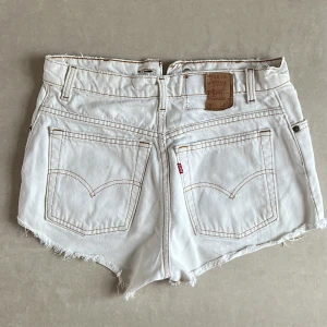Levis shorts - Vita vintage levis shorts. Märket där bak är halvt av - men så var de redan när jag köpte dem. Säljer då jag vuxit ur dem. Sitter baggy på en XS skulle jag säga. Lappen är sliten så ser inte storlek (se sista bilden). 