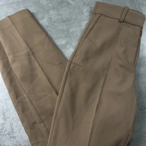 Beiga kostymbyxor - Snygga och stilrena beiga  kostymbyxor från H&M. Aldrig använda.