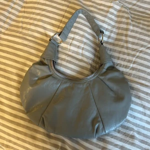 Liten läderväska i grå!  - Fin handväska som knappt blivit använd. 