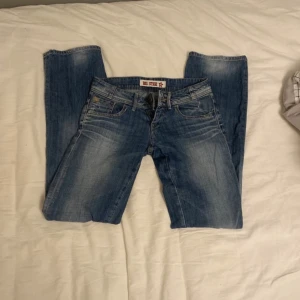 Lågmidjade jeans  - Jättesnygga lågmidjade jeans som säljs pga av att de inte kommer till anändning. Har ej använt de men köpte begagnat. Strl 26 längd 34 men skulle uppskatta strl 25 och passar mig i (165) längden då de är lite små i storlek. Inga defekter på jeansen.