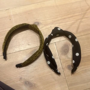 Diadem - Två superfina diadem. Ett guldglittrigt o ett svart med vita prickar. Båda har ”knutar” mitt på. Använda Max 2 gånger. Säljer då de inte kommer till användning. Vet inte vart de kommer ifrån då jag fått de i present. 1=35kr, 2=60kr. Kolla min profil❤️