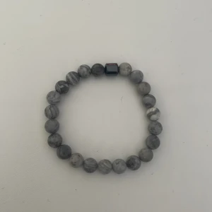 Grått armband  - Pris går att diskutera. Ett armband kostar 49 kronor om du vill ha ett till vitt eller svart kostar det 69 sammanlagt 