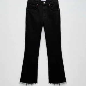 Jeans - Korta utsvängda jeans.  Svart tvätt, bra skick.  Pris 80kr, Storlek 34