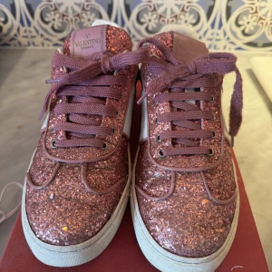 Valentino garavani flycrew sneakers  - Unika rosa glittriga skor, har några slitningar bland annat saknar de en nit men det är inget man tänker på. Original låda och påse ingår. 