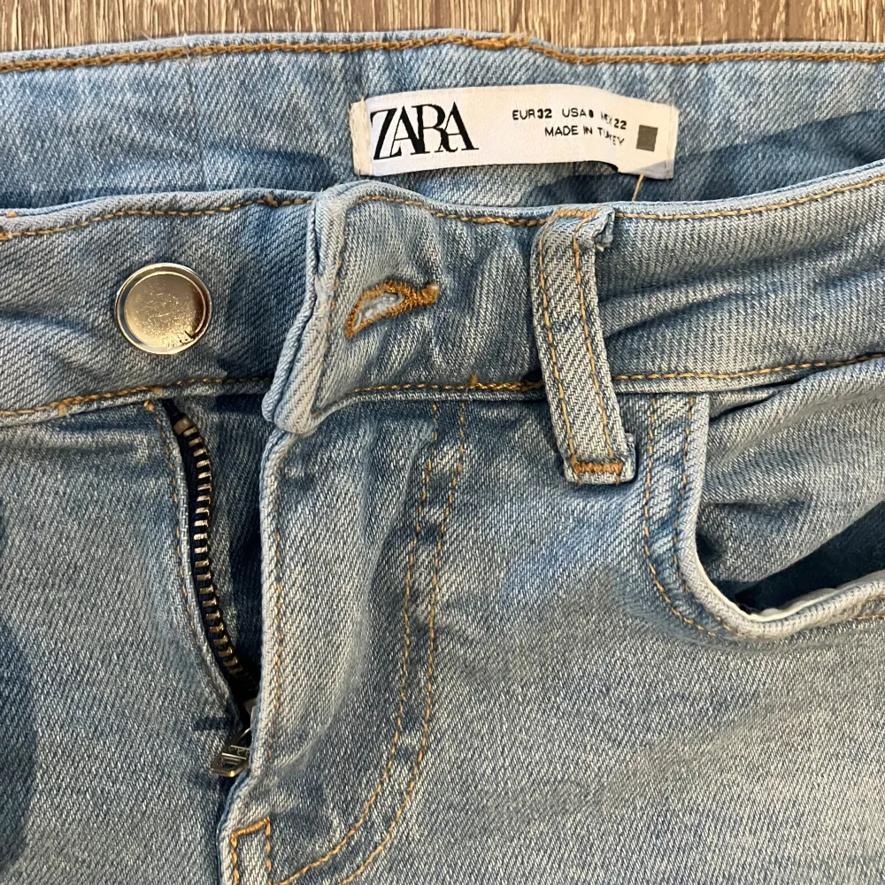 Ett par ljusblå jeansbyxor från Zara med dragkedja och knapp framtill. Byxorna har en klassisk femficksdesign och är tillverkade i ett bekvämt denimtyg.. Jeans & Byxor.