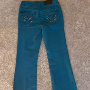 Säljer dessa lågmidjade turkosa jeans. innerbenslängden är 71cm och midjemåttet är 36cm