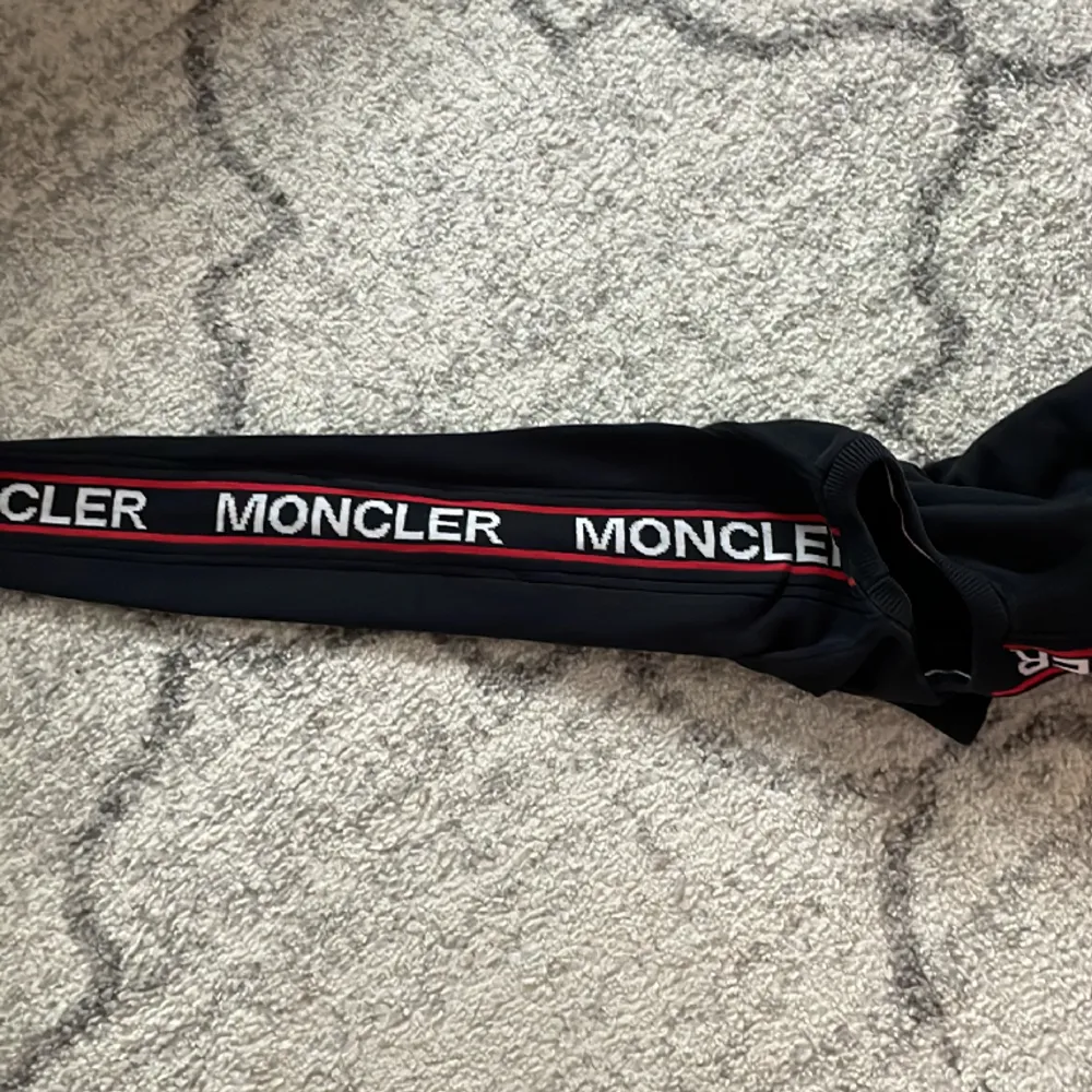 Selling a black Moncler sweater, it got a small hole.. Hoodies.