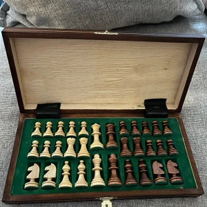 Schackspel i trä, magnetisk - Schackspel i trä med förvaring, magnetisk. I mycket god skick.   Mått:  Öppet 27x27 cm Höjd ca 2 cm