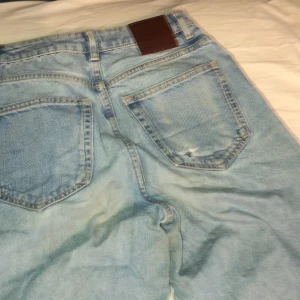 Denim wide jeans med hål - Ljusblåa denim jeans från bok bok med hål vid knäna och ett hål i högra bakfickan