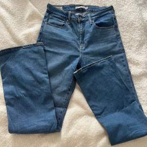 Blå Högmidjade bootcut Levi’s jeans  i storlek 28 med mycket stretch 