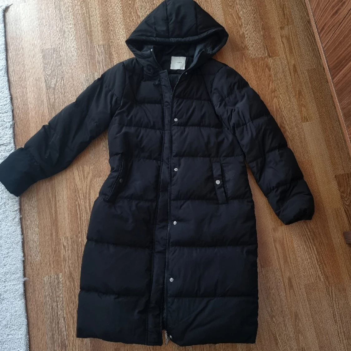 Lång dun-pufferjacka