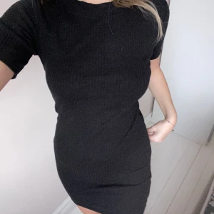 Svart ribbad klänning - Säljer nu min ribbade klänning ifrån ”zara trafaluc”. Den är fem cm nedanför min rumpa och jag är 171 cm lång. Helt okej skick nästan aldrig använd. 